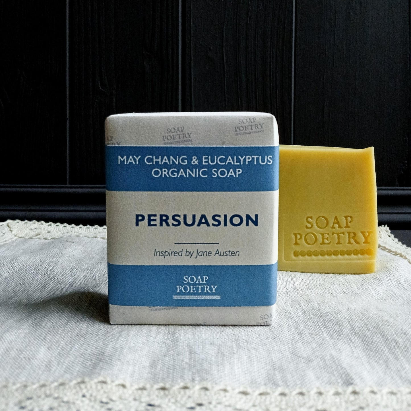 Bar of soap with packaging labeled 'Persuasion' by Soap Poetry on a textured surface.