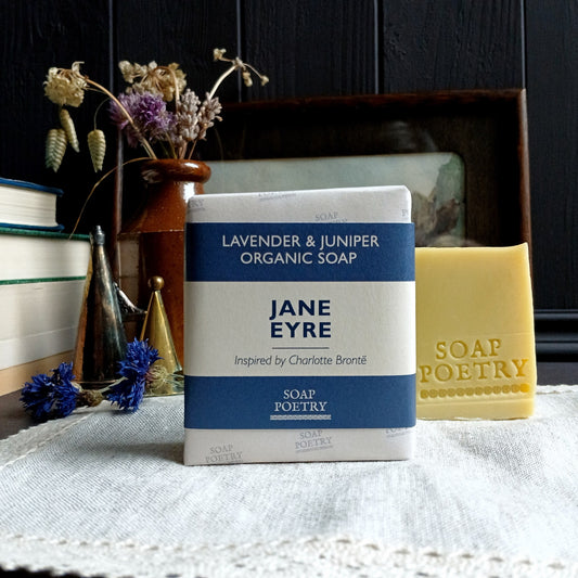 Bar of soap with 'Jane Eyre' packaging on a textured surface with decorative elements.