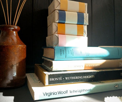 Stack of books with a decorative vase on a dark background