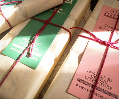 Pretty soaps packaged paper and with red cotton string ties, with bookmarks tucked under the string.