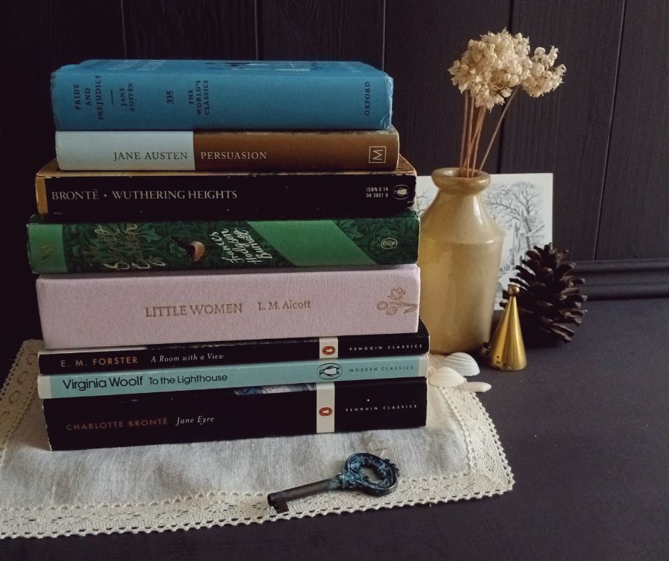Stack of books on a lace doily with decorative elements including an antique iron key, a brass candle snuffer and a pine cone. 