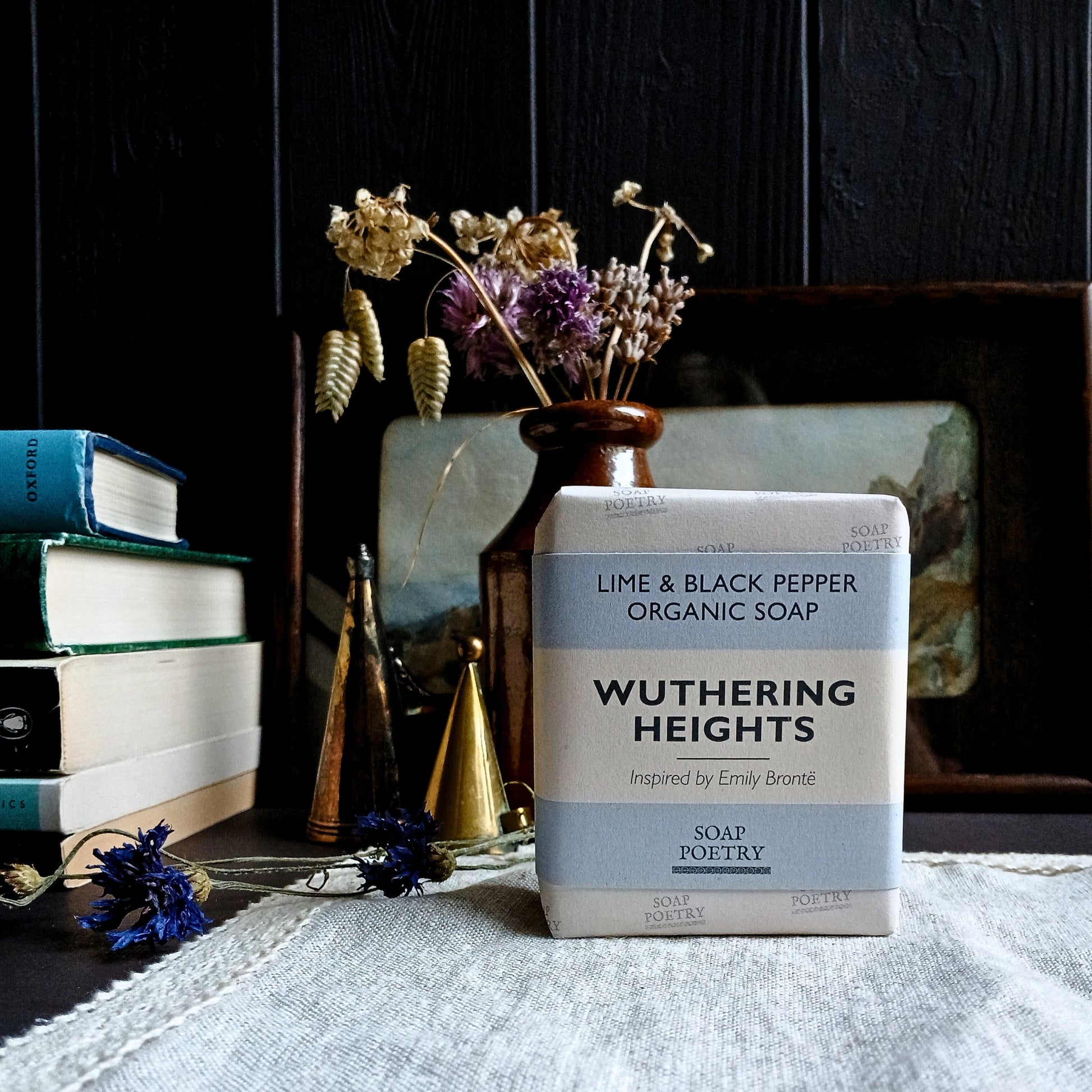 Soap bar titled 'Wuthering Heights' by Soap Poetry on a surface with books and decorative items in the background.